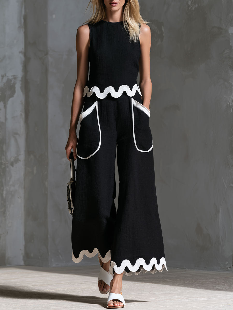 Retro-Set mit Color-Blocking aus schwarzem, ärmellosem Baumwoll-Leinen-Oberteil mit Wellenbesatz und Hose