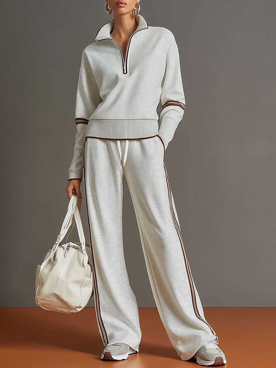 Retro-sportliches Set: Grau-weißes Sweatshirt mit Ripsband und halbem Reißverschluss und weit geschnittene Hose